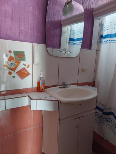 a bathroom with a sink and a mirror at Hotel Casa Ramos in Panajachel