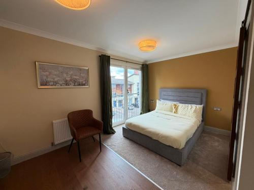 a bedroom with a bed and a chair and a window at Right Choice by 3 Crowns in Dundee