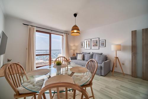 a living room with a table and chairs and a couch at Apartment Emma complex Carpe Diem Balchik in Balchik