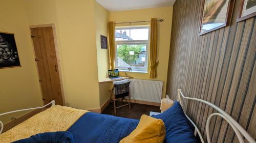 a bedroom with a bed and a window and a desk at Hot Tub Home - Stay in Stoke on Trent