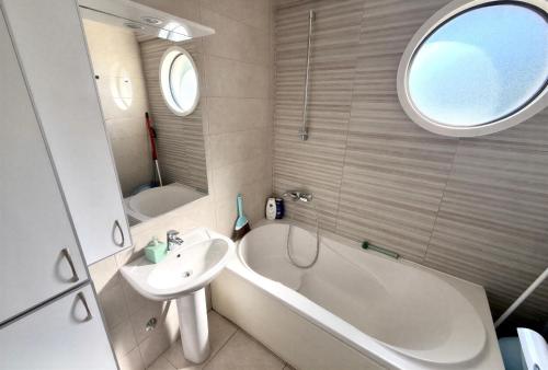 a bathroom with a tub and a sink and a bath tub at Boreti Apartment in Budva