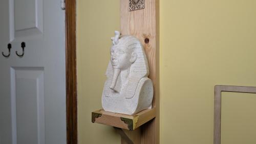 a statue of a woman on a shelf next to a door at Hot Tub Home - Stay in Stoke on Trent
