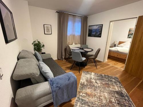 a living room with a couch and a table at Apartment Enarina in Telfs in Telfs