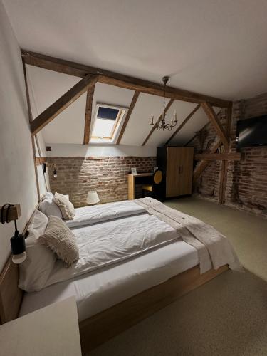a bedroom with a large bed in a attic at TimHouse in Timişoara