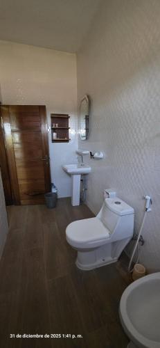 a bathroom with a toilet and a sink at Tata Khane in Ngaring