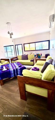 a bedroom with several beds in a room at Tata Khane in Ngaring