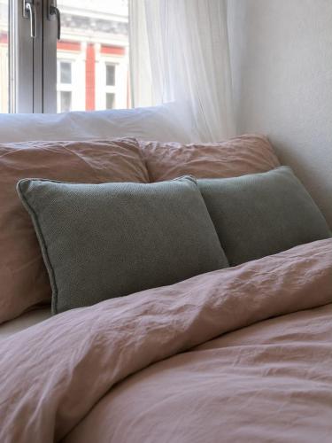 a pillow sitting on top of a bed at Charming room central Oslo in Oslo