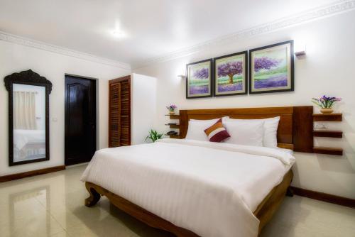 a bedroom with a large bed in a room at Reasey Boutique Villa in Siem Reap