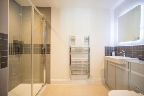 a bathroom with a shower and a sink at Orange House, Southwold in Southwold