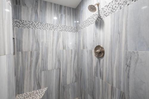 a bathroom with a shower with a shower curtain at Chandler Galveston in Chandler