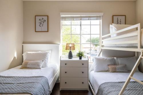 a bedroom with two beds and a window at Chandler Tyson in Chandler