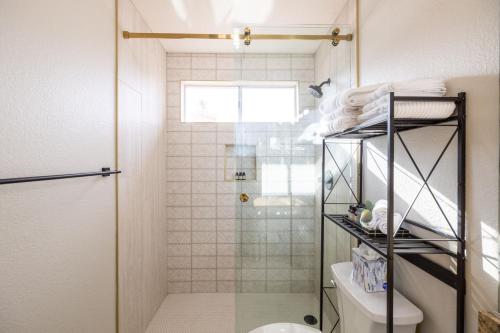 a bathroom with a shower and a toilet at Chandler Tyson in Chandler