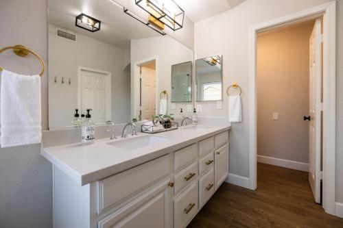 a bathroom with a sink and a large mirror at Gilbert Douglas in Gilbert
