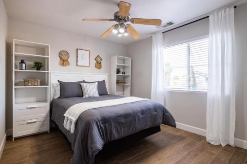 a bedroom with a bed and a ceiling fan at Gilbert Douglas in Gilbert