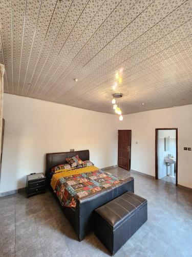 a bedroom with a bed and a coffered ceiling at S & J Lodge with high speed Starlink WiFi in Tamale