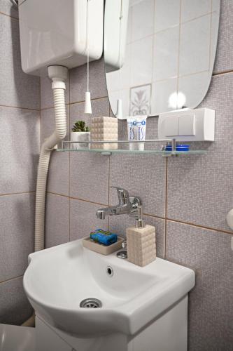 a bathroom with a sink and a mirror at Ana Central Studio in Smederevo