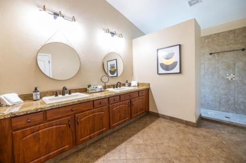 a bathroom with two sinks and a shower at Gilbert Beachcomber in Gilbert