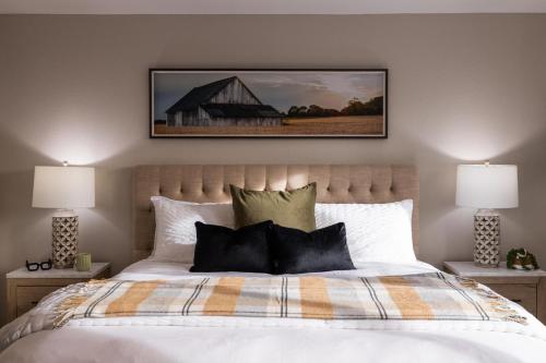 a bedroom with a large bed with two lamps at Gilbert Comstock in Gilbert