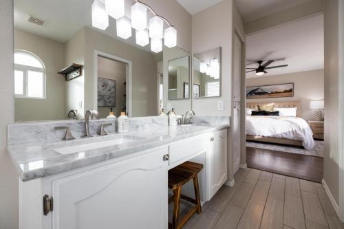 a bathroom with two sinks and a large mirror at Gilbert Comstock in Gilbert