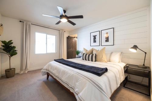 a bedroom with a large bed with a ceiling fan at Gilbert East Laurel in Gilbert