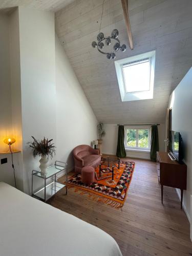a living room with a couch and a chair at La maisonnette in Saussemesnil