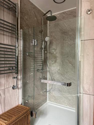 a shower with a glass door in a bathroom at Studio A - Newly renovated 2 bed studio in Nottingham