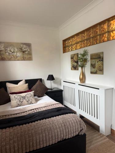 a bedroom with a bed and a vase on the wall at Studio A - Newly renovated 2 bed studio in Nottingham
