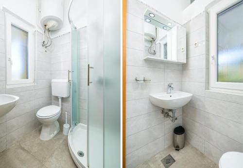 a bathroom with a toilet and a sink and a shower at Garden House Premantura in Premantura