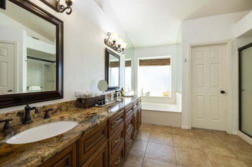 a bathroom with a sink and a large mirror at Glendale Sack in Glendale