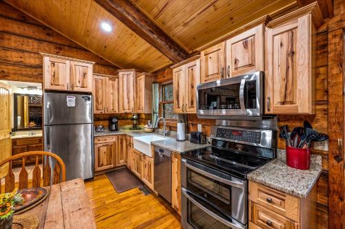 a kitchen with wooden cabinets and stainless steel appliances at Wildwood in Townsend