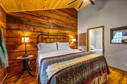 a bedroom with a bed and a wooden wall at Wildwood in Townsend