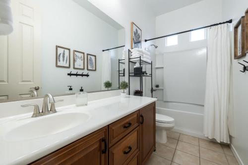 a white bathroom with a sink and a toilet at Queen Creek on 193rd in Queen Creek