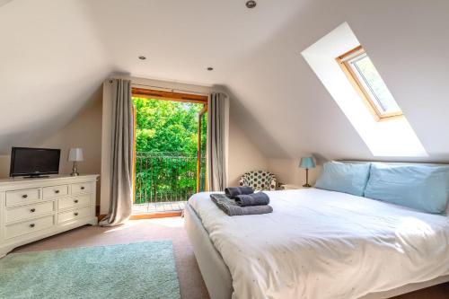 a bedroom with a large bed and a window at 4 Bed in Fakenham oc-1261 in Thursford