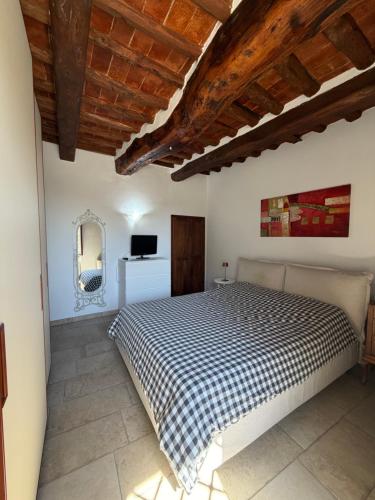 a bedroom with a bed and a television in it at Casetta di pisolo in Pistoia