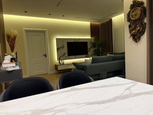 a living room with a couch and a television at Modern Luxury Apartment-City Center-Walk Anywhere in Durrës