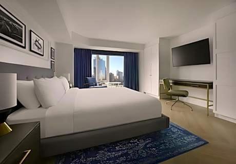 a bedroom with a large white bed and a television at Aloft by Marriott New Orleans Downtown in New Orleans