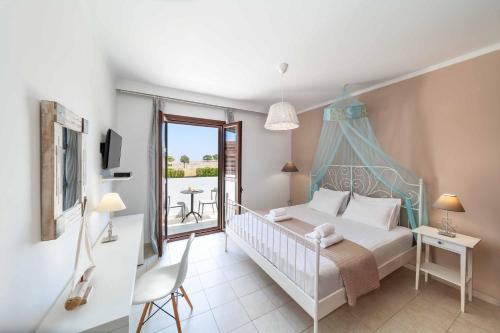 a bedroom with a bed and a balcony at Lindos Emerald in Lindos