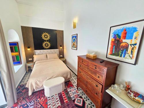 a bedroom with a bed and a dresser in it at Riad Boutique Baba in Rabat