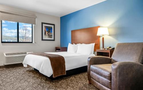 a hotel room with a bed and a chair at My Place Hotel-Missoula, MT in Missoula
