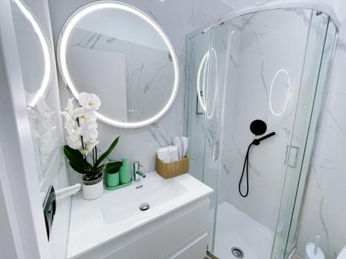 a white bathroom with a sink and a mirror at Ciao Termini in Rome