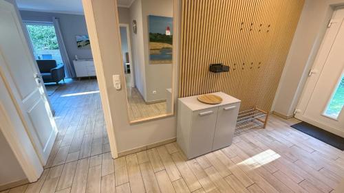 a room with a bathroom with a sink and a mirror at Bauernhof Claussen Fehmarn in Fehmarn