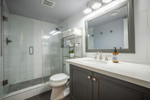 a bathroom with a toilet and a sink and a mirror at Scottsdale Camelback in Scottsdale