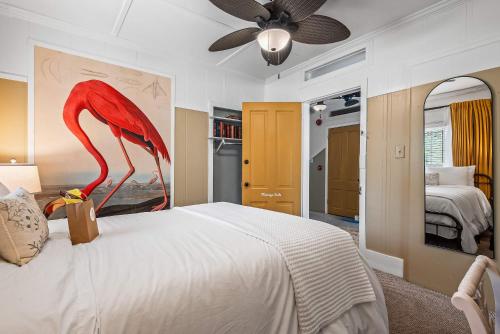 a bedroom with a large bed with a red bird on it at Old Carrabelle Hotel Flamingo Suite in Carrabelle