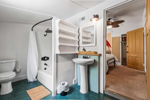 a bathroom with a toilet and a sink at Old Carrabelle Hotel Flamingo Suite in Carrabelle