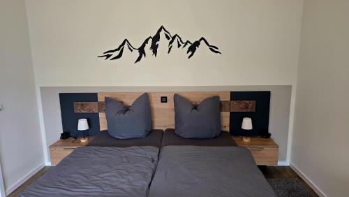 a bedroom with a bed with two pillows at Ferienwohnung Pollig in Rech