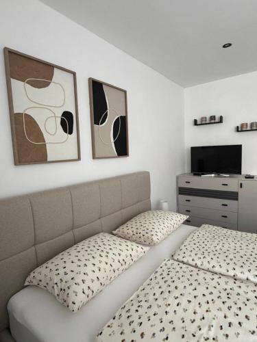 a bedroom with a bed and a dresser at Apartman Tomislav in Slavonski Brod
