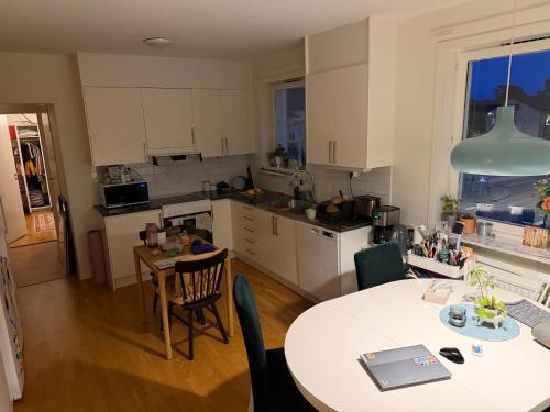 a kitchen and dining room with a table and chairs at PRIVATE ROOM in a shared apartment in Västerås