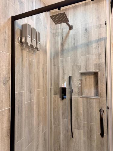 a shower with a glass door in a bathroom at BP STAYS - Hotel-Style, No Host, Professionally Managed ID312 in Jersey City