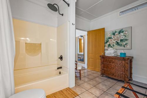 a bathroom with a tub and a toilet at Old Carrabelle Hotel Magnolia Suite in Carrabelle