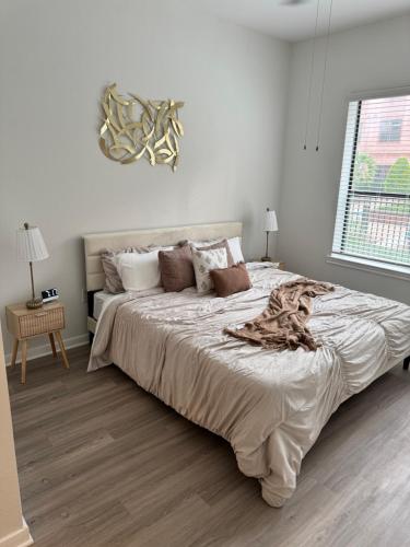 a white bedroom with a large bed and a window at The Experience in Houston